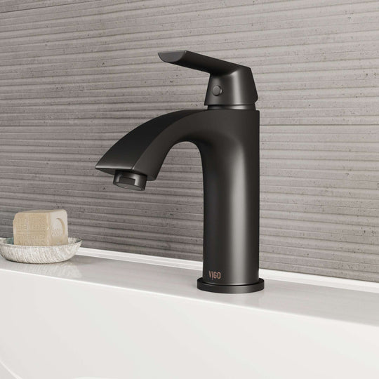 VIGO Penela matte black single-hole bathroom faucet with curved spout and lever handle, installed in modern bathroom