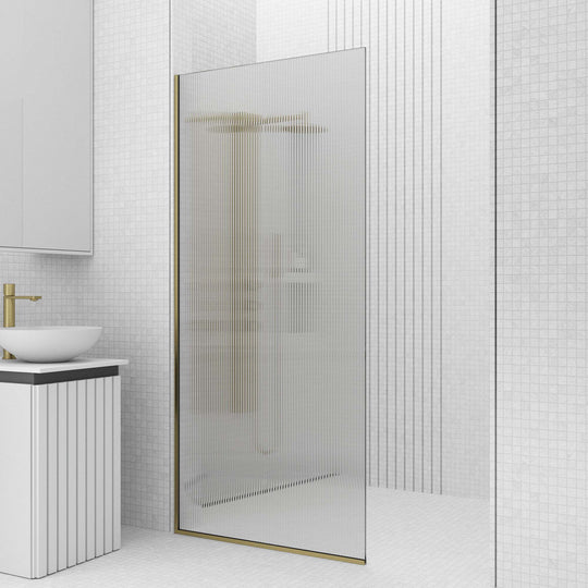 Modern matte gold shower screen featuring fluted tempered glass and reversible door installation