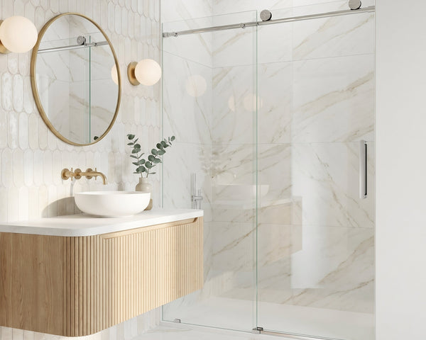 Frameless clear-glass sliding shower door in a bright, modern tiled bathroom