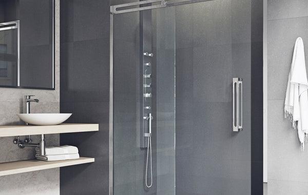 Elegant marble bathroom featuring a bathtub, sink, and glass shower enclosure.
