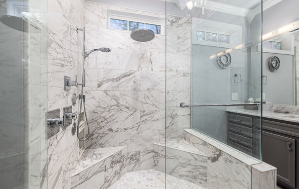 Elegant marble bathroom with contemporary design and glass shower.