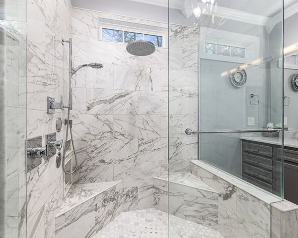 Elegant marble bathroom with contemporary design and glass shower.