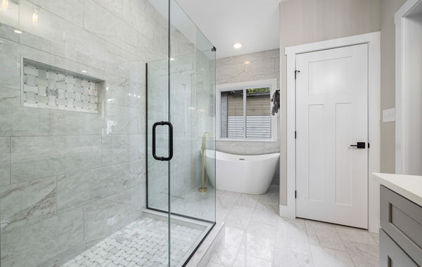 Bright modern bathroom featuring a glass shower and freestanding bathtub. Perfect for design inspiration.