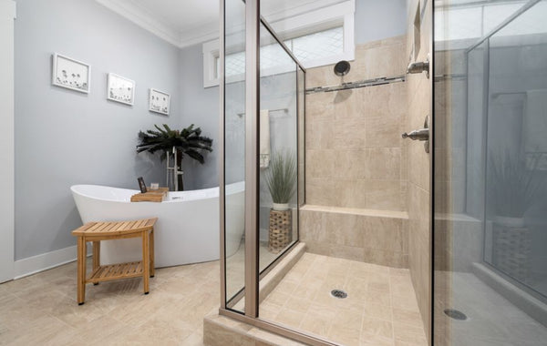 A clean, modern bathroom featuring a bathtub and glass shower with minimalist decor.