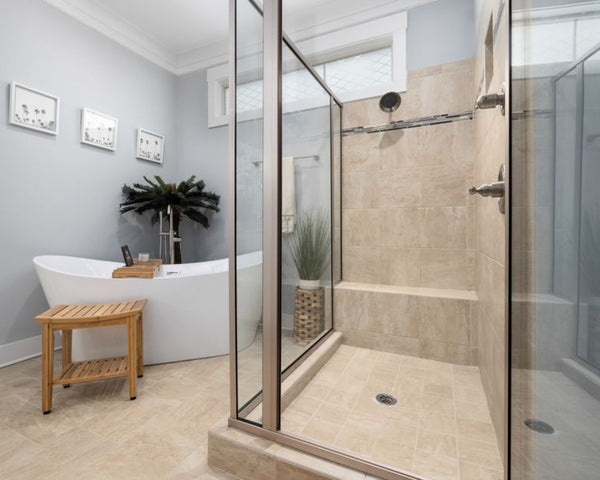 A clean, modern bathroom featuring a bathtub and glass shower with minimalist decor.