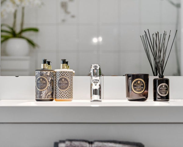 Elegant bathroom display with luxury accessories and sleek reflection.