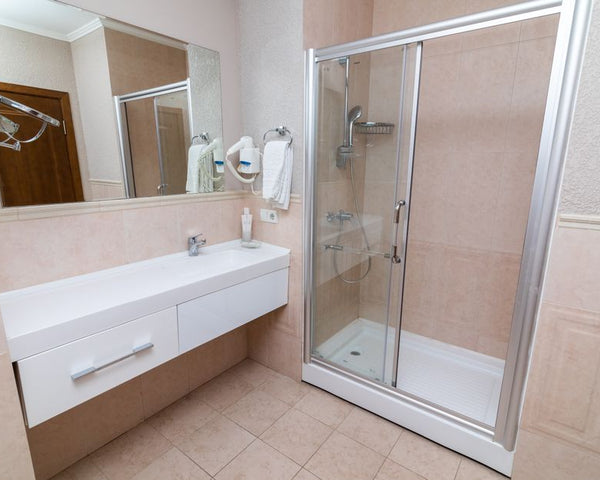 Contemporary bathroom showcasing a sleek shower cabin and minimalist interior design.