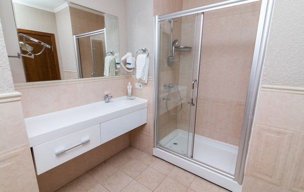 Contemporary bathroom showcasing a sleek shower cabin and minimalist interior design.
