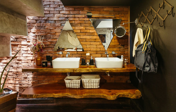 A stylish rustic bathroom featuring brick walls, wood elements, and modern fixtures, creating a unique charm.
