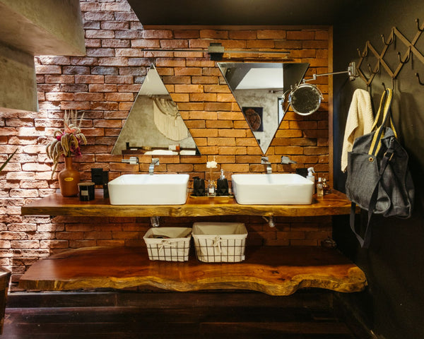 A stylish rustic bathroom featuring brick walls, wood elements, and modern fixtures, creating a unique charm.