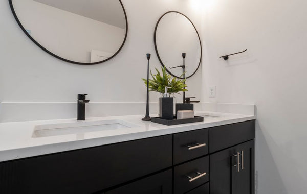Sleek black and white bathroom vanity featuring double sinks and elegant design.