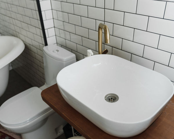 Stylish bathroom interior featuring a ceramic sink, bathtub, and modern fixtures.