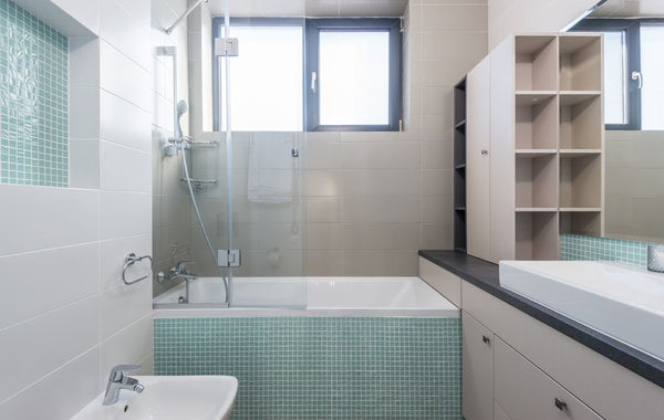A sleek and contemporary bathroom featuring minimalist design and modern amenities.