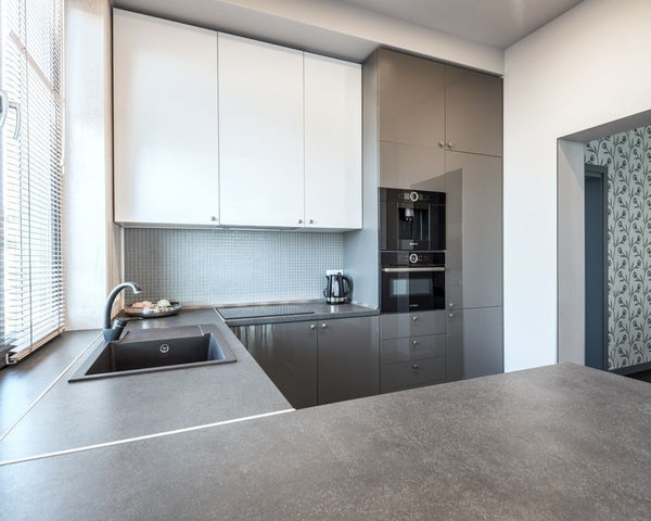 Stylish and sleek modern kitchen interior with high-gloss cabinetry and minimalist design.