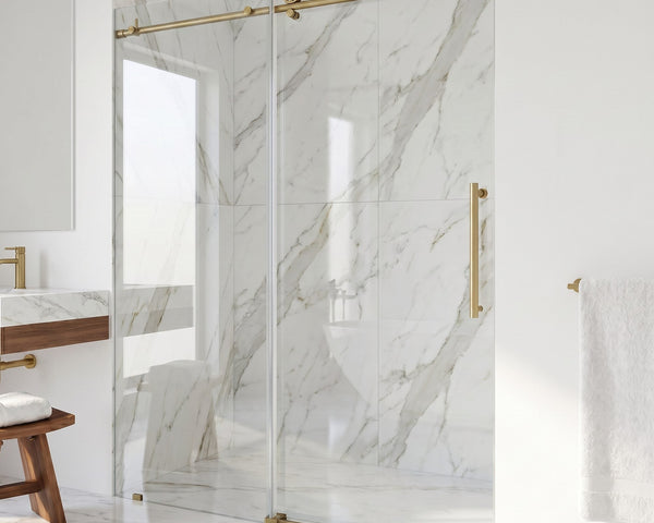 VIGO Cass Elan frameless sliding shower door with matte brushed gold hardware in a white marble bathroom