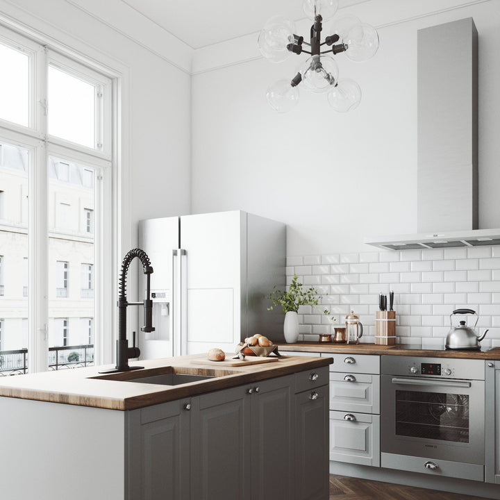 VIGO Edison pull-down kitchen faucet in matte black on a deck plate at a wood-topped island in a bright white kitchen with gray cabinets