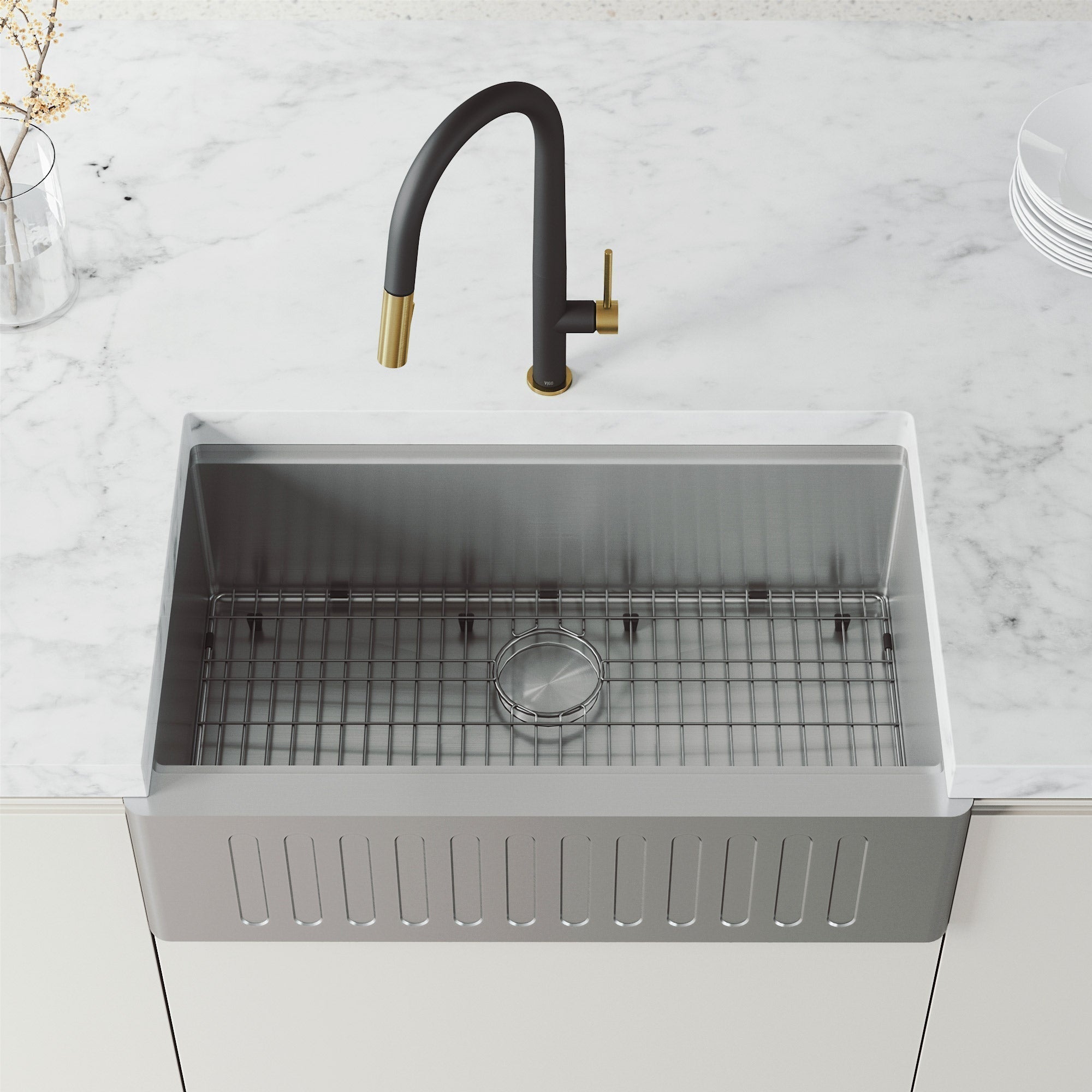 Deck-mounted black and gold faucet with 360-degree swivel and included sprayer head