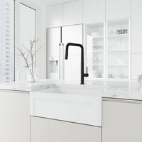 Matte black kitchen faucet with pre-rinse function and included hose and mounting materials