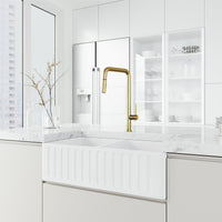 Matte brushed gold kitchen faucet with pre-rinse function and included hose and mounting materials