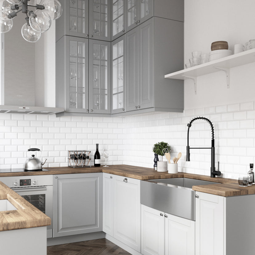 Deck-mounted kitchen faucet with included hose, sprayer head, and matte black finish