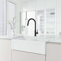 Brass construction kitchen faucet in matte black with included hose and sprayer