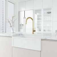 Brass kitchen faucet in matte brushed gold with included hose and sprayer