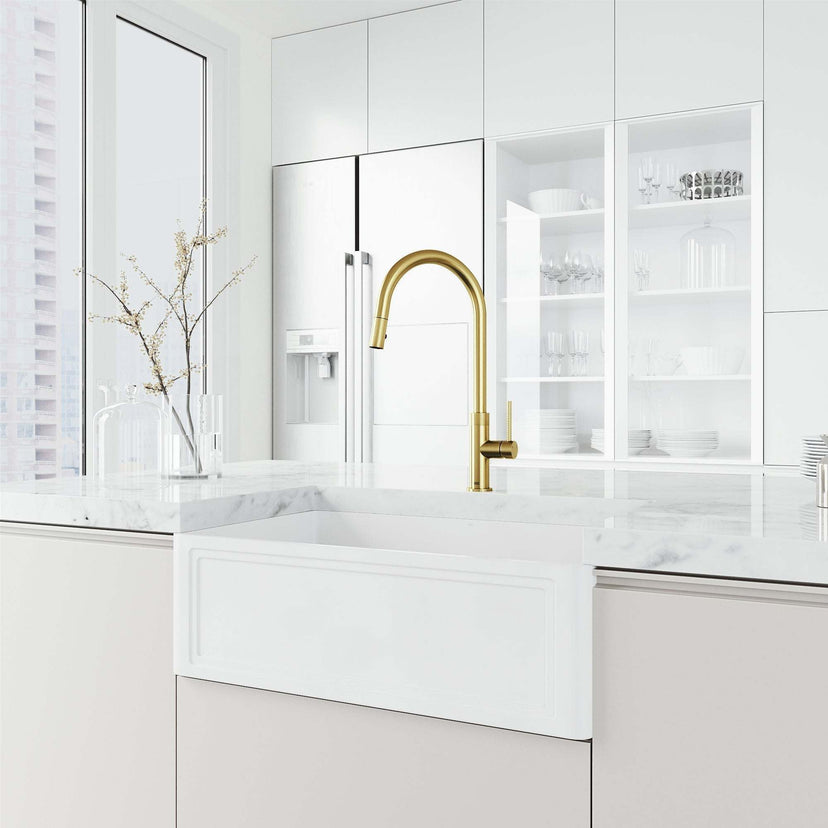 Brass kitchen faucet in matte brushed gold with included hose and sprayer