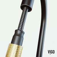 Spot-resistant black and gold faucet with secure docking and pre-rinse