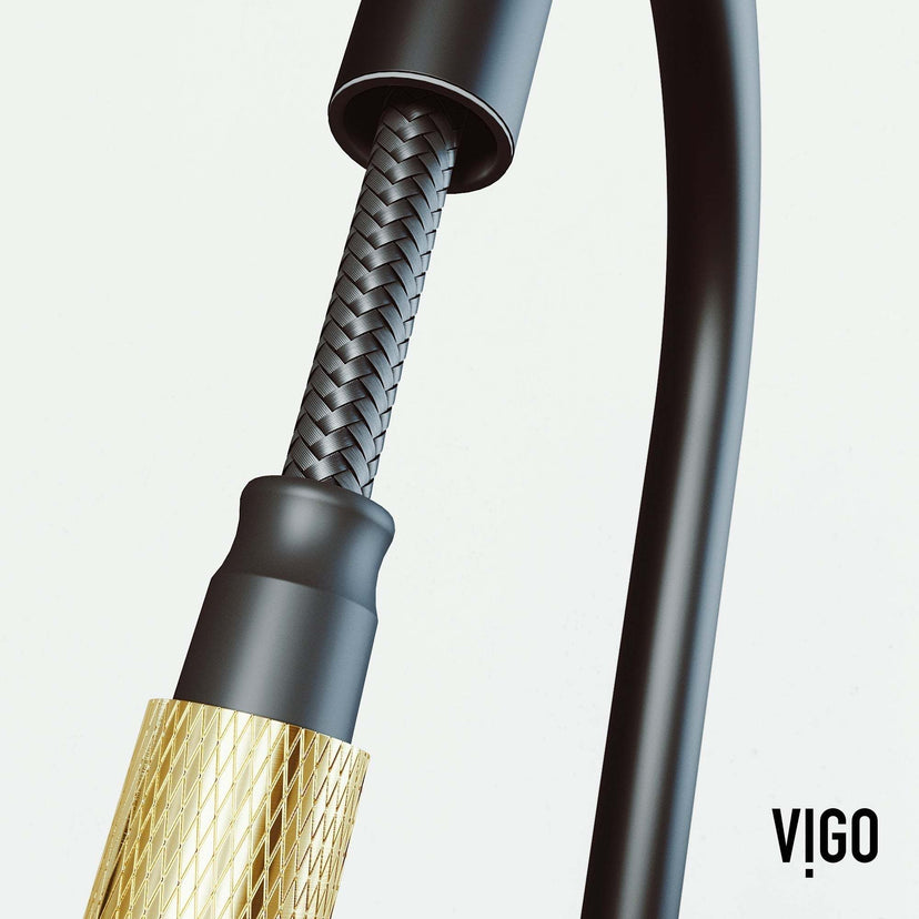 Spot-resistant black and gold faucet with secure docking and pre-rinse