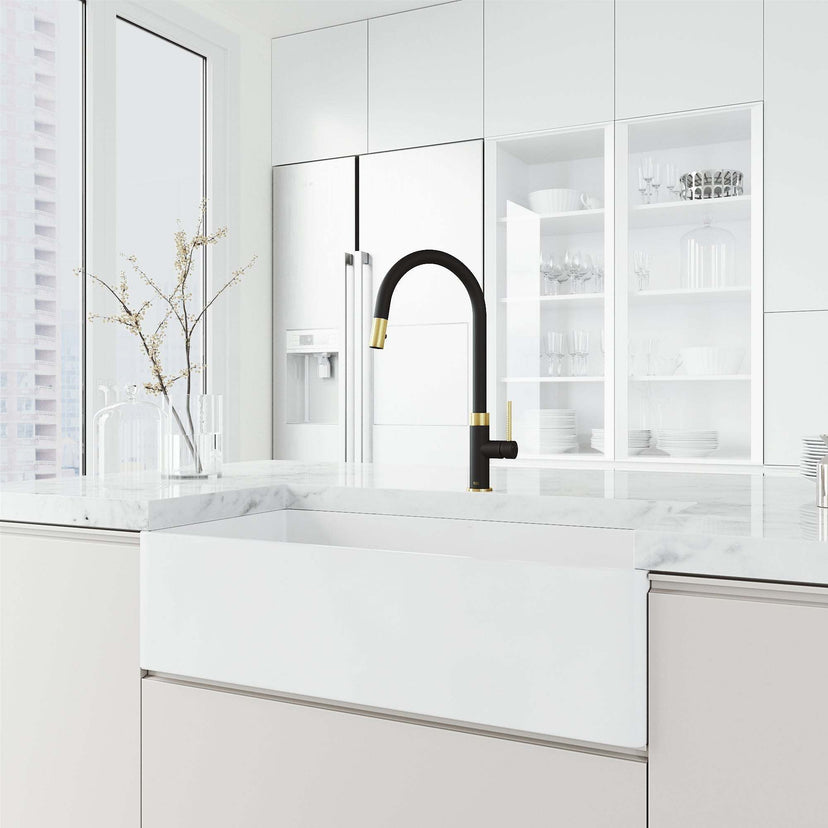 Brass kitchen faucet in black and gold with included hose and sprayer