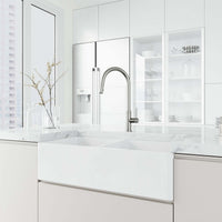 Brass kitchen faucet in stainless steel with included hose and sprayer