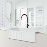 Brass kitchen faucet in black and steel with included hose and sprayer