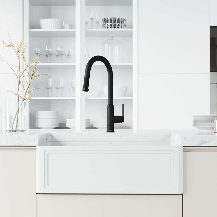 Pull-down kitchen faucet with secure docking station and spot-resistant finish