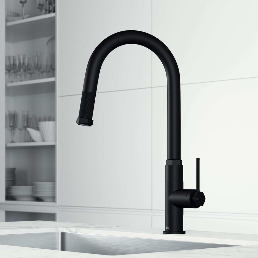 Brass kitchen faucet with matte black finish and dual-mode sprayer