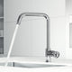 Modern deck-mounted kitchen faucet in chrome with lever handle and sprayer docking station