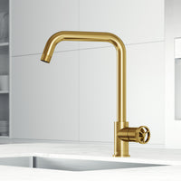 Kitchen faucet with 360-degree swivel spout and secure docking in brushed gold