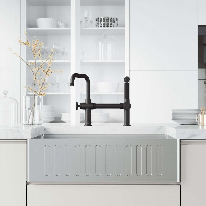 Chrome kitchen faucet with pull-out sprayer and exposed bridge design