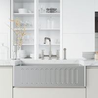 Deck mount kitchen faucet with included supply lines and sprayer head in stainless steel