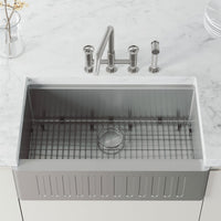 High-arc kitchen faucet with knob handles and side spray activation in stainless steel finish