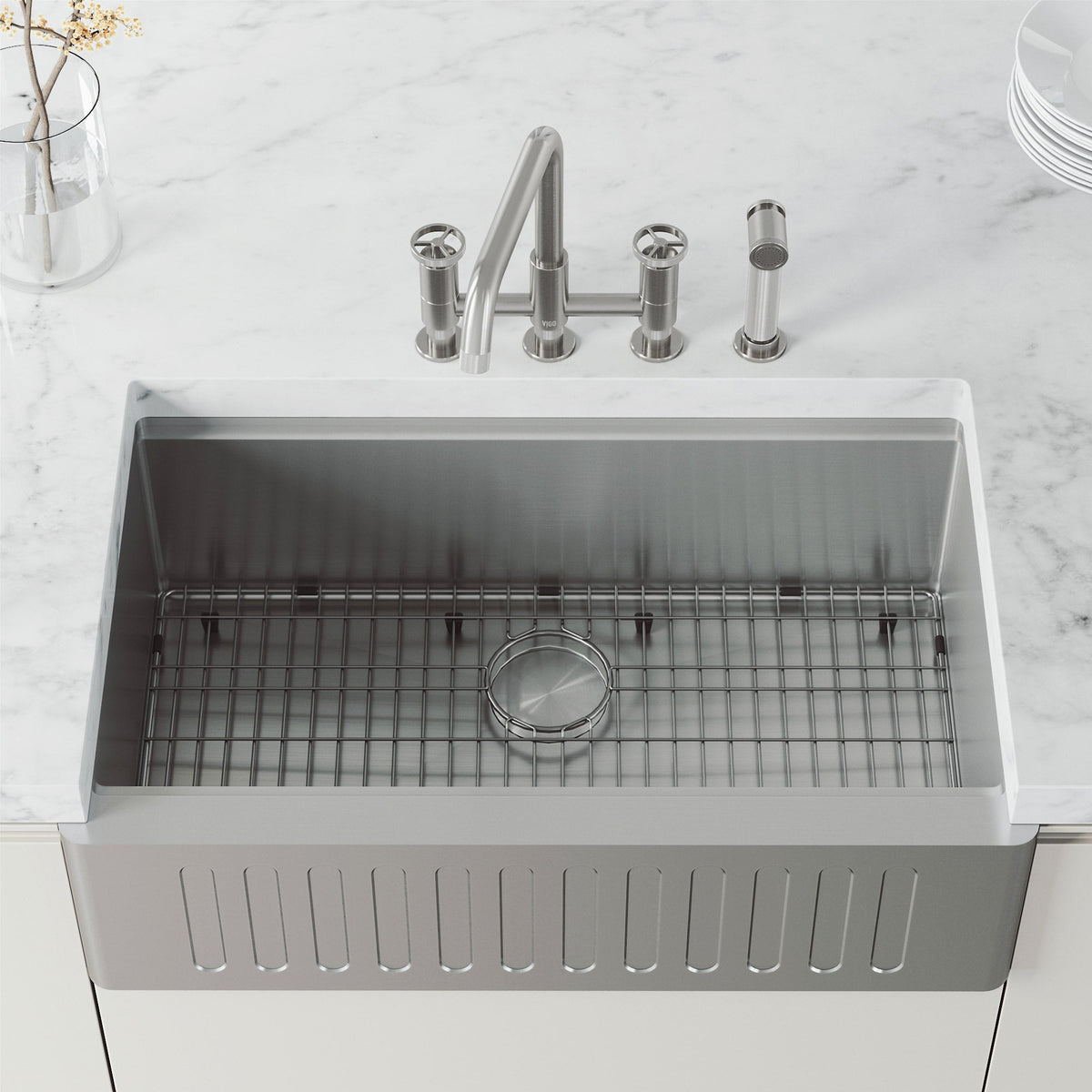 High-arc kitchen faucet with knob handles and side spray activation in stainless steel finish