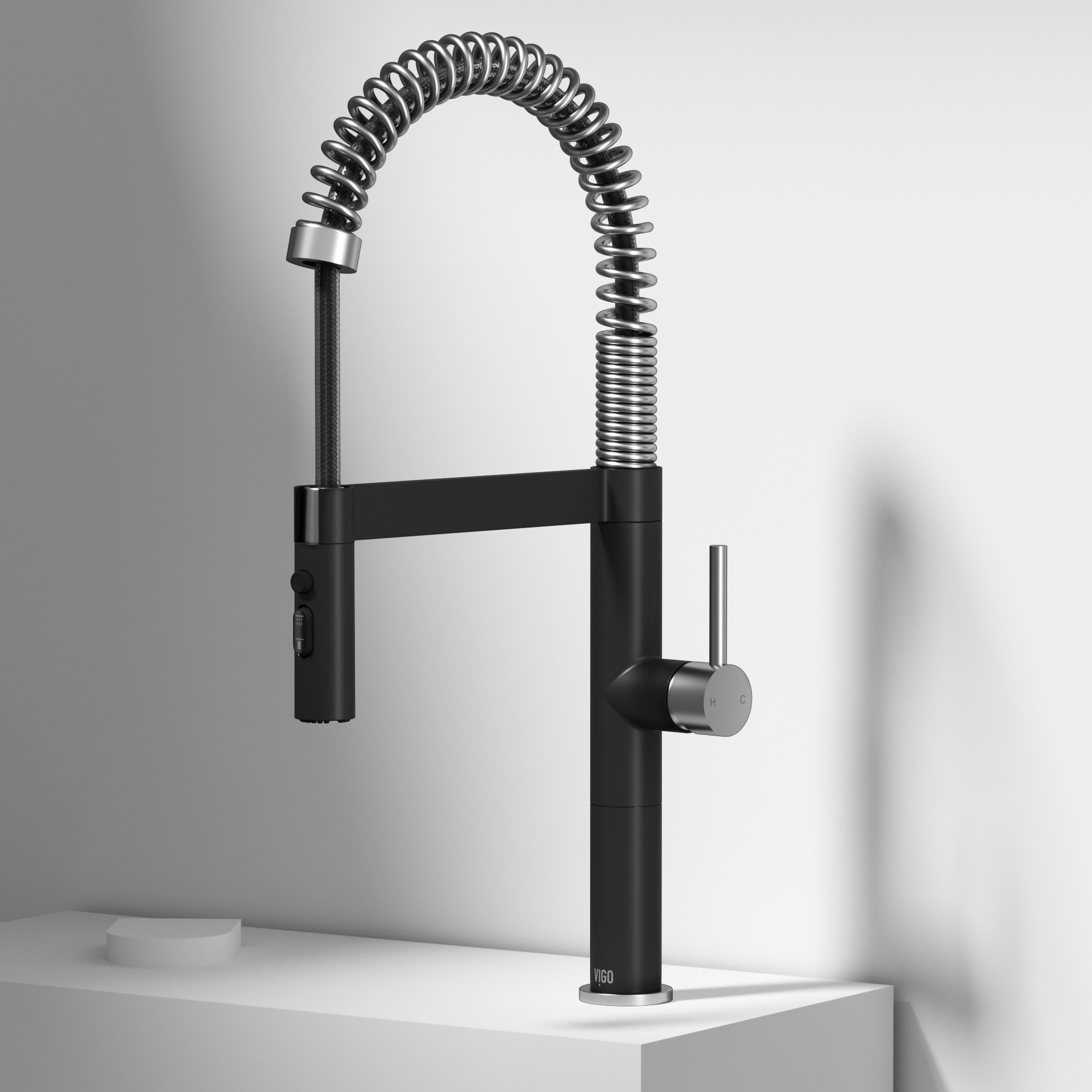 Modern kitchen faucet with high-arc spout and pull-down sprayer in steel and black