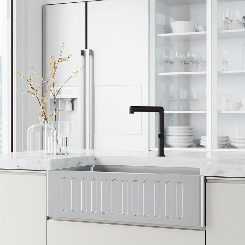 Matte black kitchen faucet with included hose and mounting materials