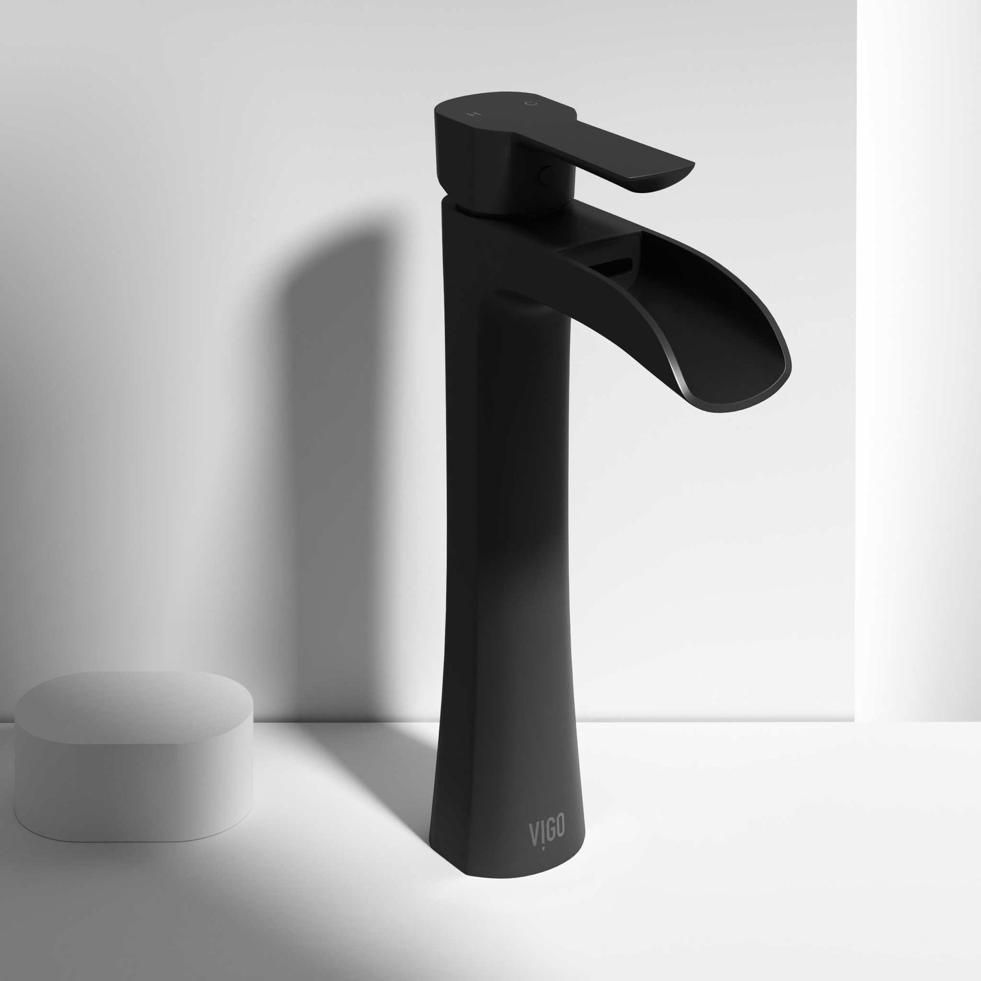 Matte black vessel faucet with waterfall spout and lever handle