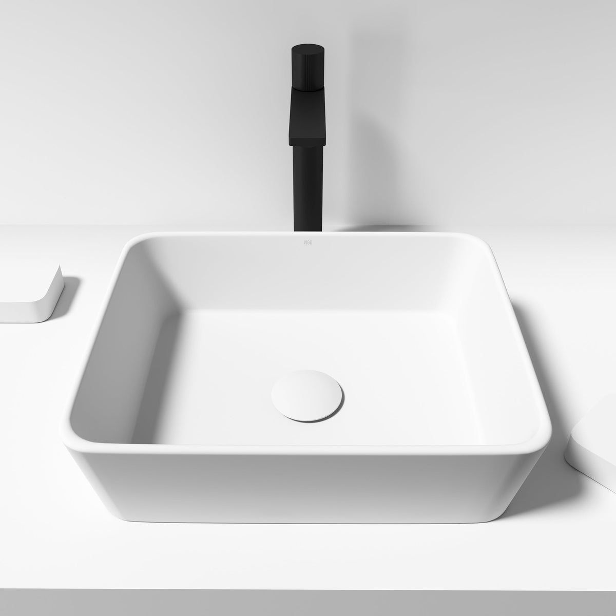 Modern rectangular matte white vessel sink made of matte stone
