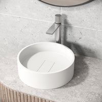 Round matte white cast stone vessel sink with modern design and scratch-resistant finish