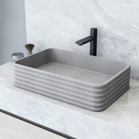 Gray concrete vessel sink with rectangular shape and modern design