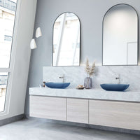 Glass vessel sink with modern design and royal blue color for bathrooms