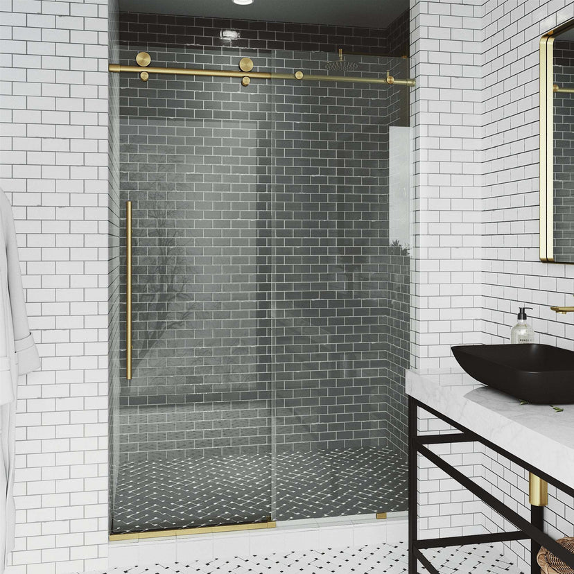 Clear glass frameless shower door with matte gold bar handle, 44-48 in. width