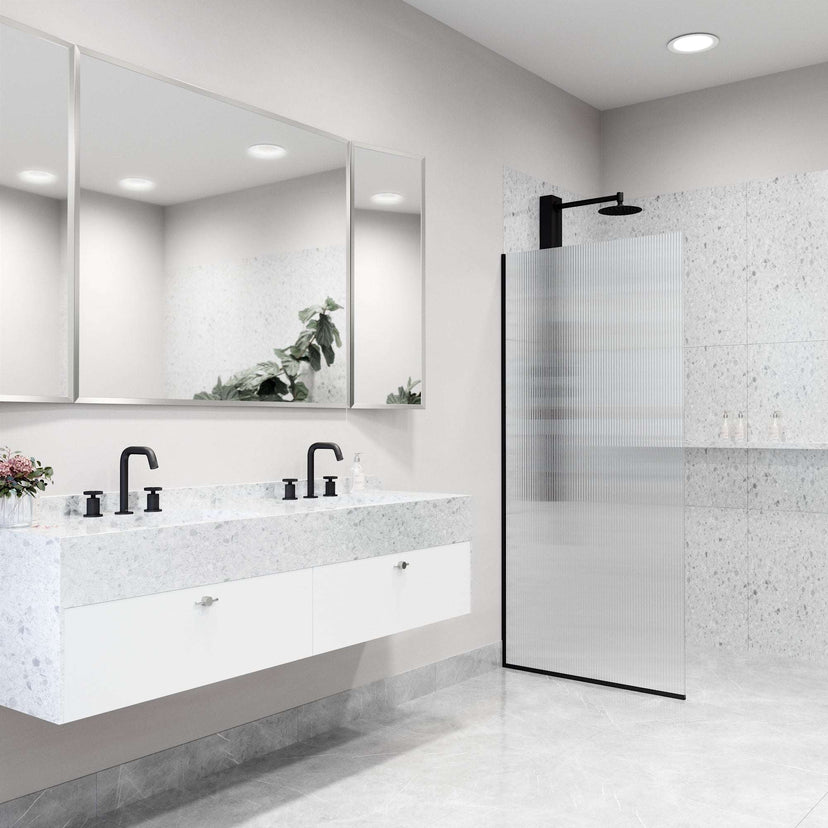 Fixed shower screen with matte black frame, fluted tempered glass, and reversible door