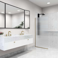 Fixed shower screen with matte gold frame, fluted tempered glass, and reversible door